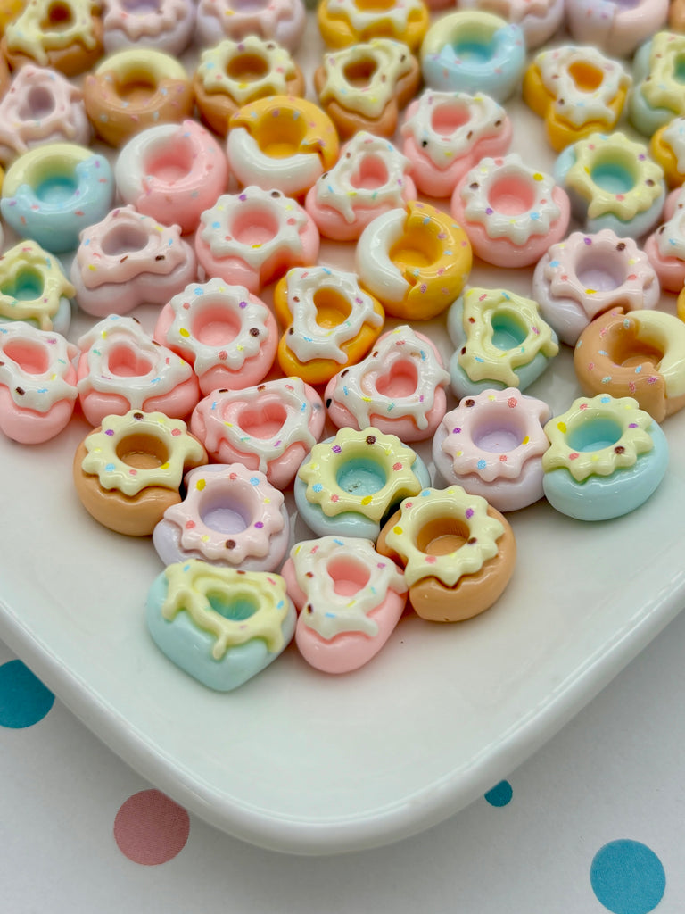 a white plate topped with lots of colorful donuts