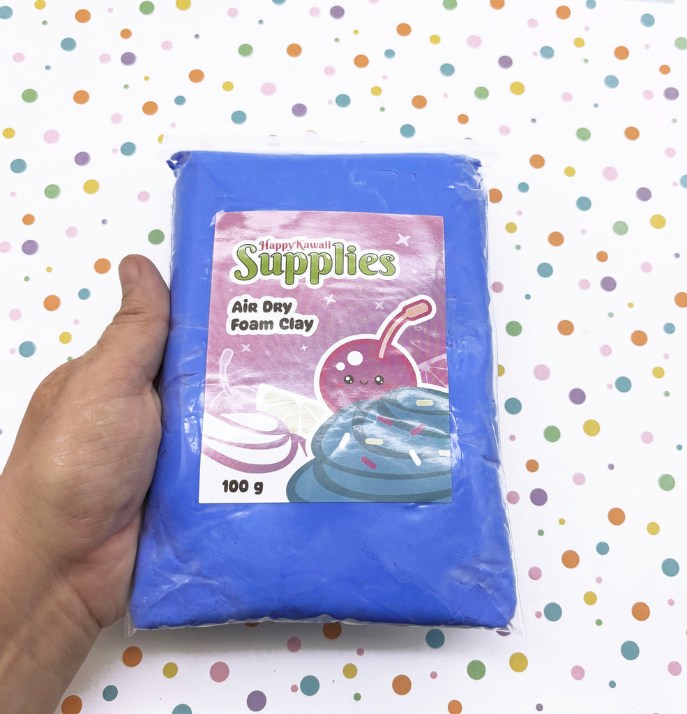 A hand is holding a package of air dry foam clay against a background with colorful polka dots.