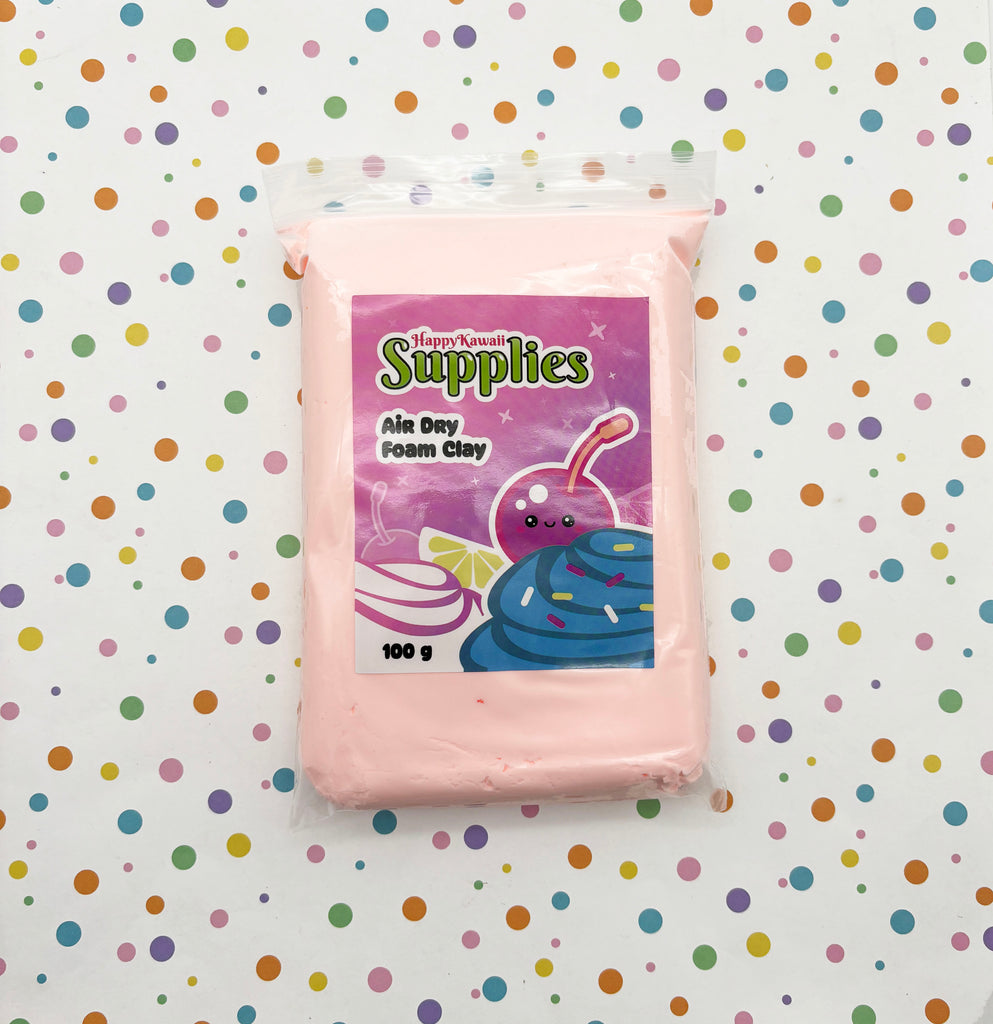 A package of pink foam clay is placed on a background with colorful polka dots.