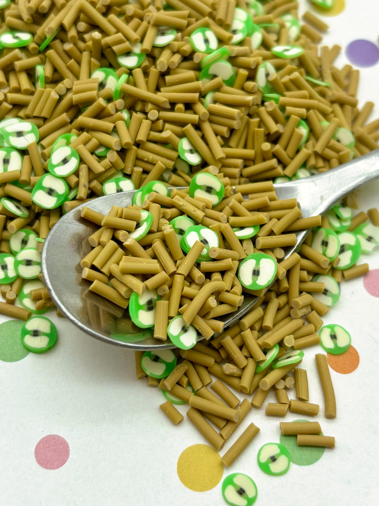 a spoon full of green and white sprinkles