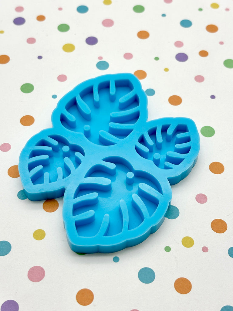 a blue cookie cutter sitting on top of a table