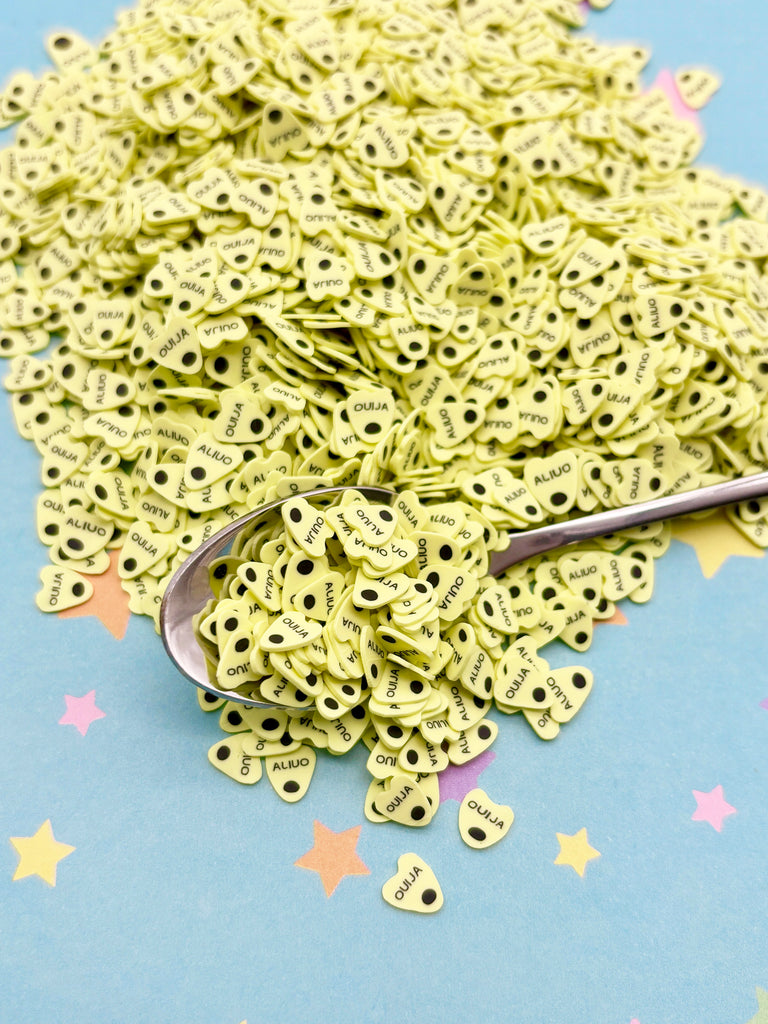 a pile of green paper with a spoon on top of it