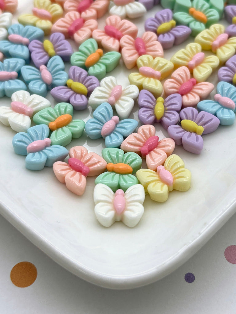 a white plate topped with lots of colorful butterflies