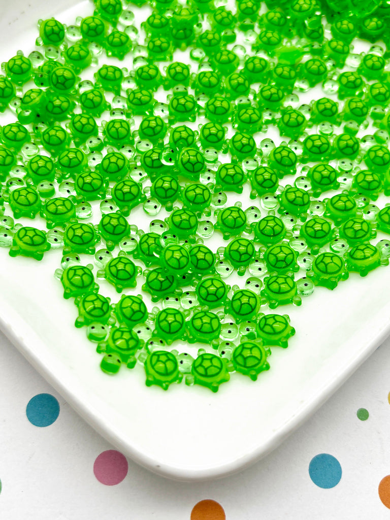 a white plate topped with lots of green beads