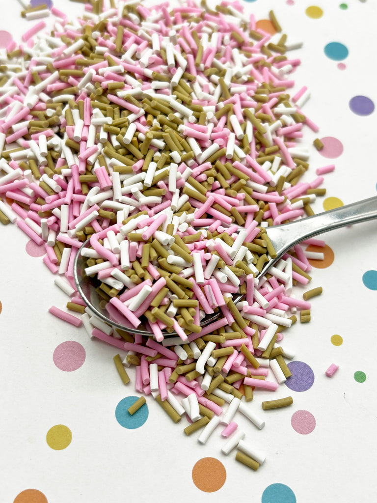 a spoon filled with sprinkles on top of a table