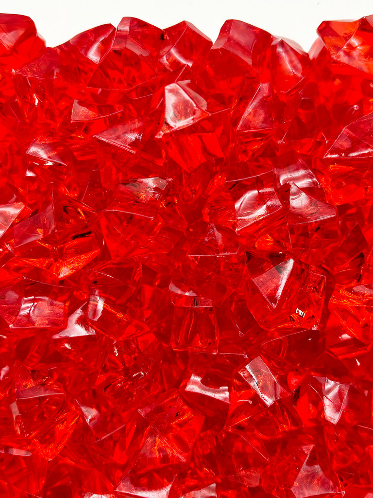 a close up of a pile of red glass