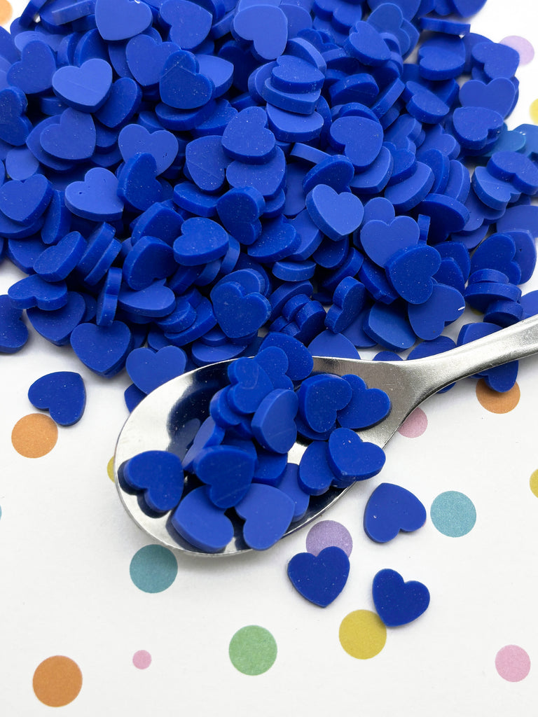 a spoon full of blue heart shaped confetti