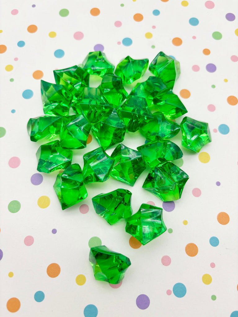 a pile of green crystals sitting on top of a table