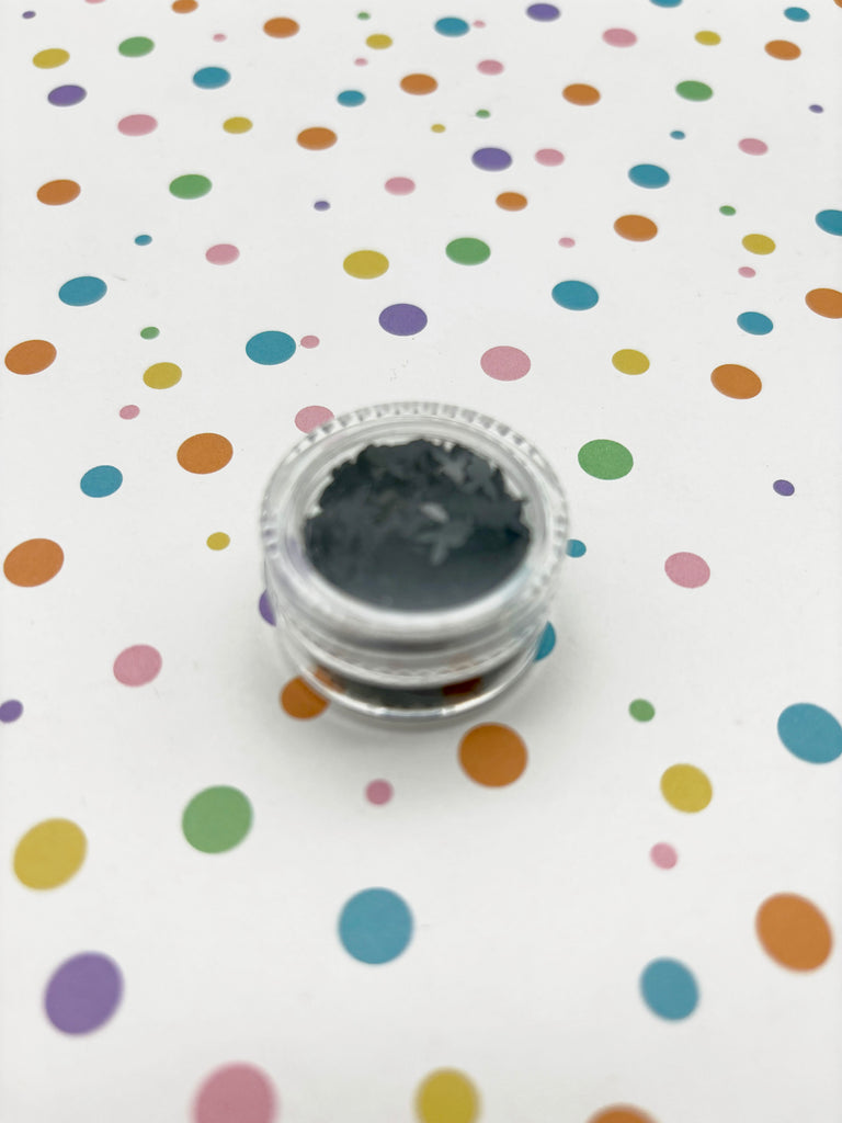 a close up of a bottle on a polka dot table cloth