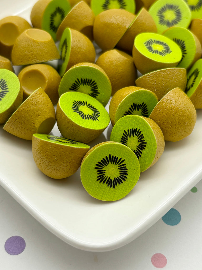 a white plate topped with kiwi pieces on top of a table