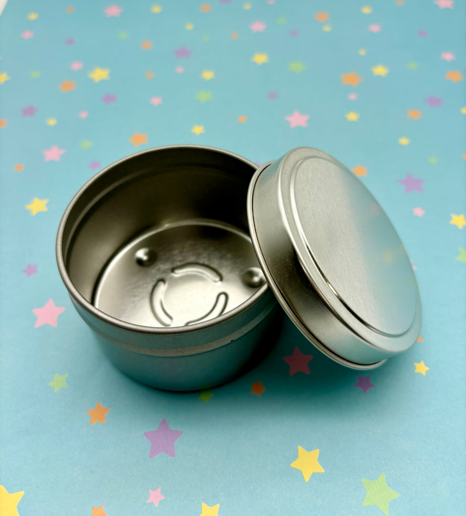 two tins sitting on top of a blue table