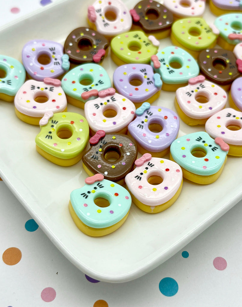 a white plate topped with donuts covered in frosting