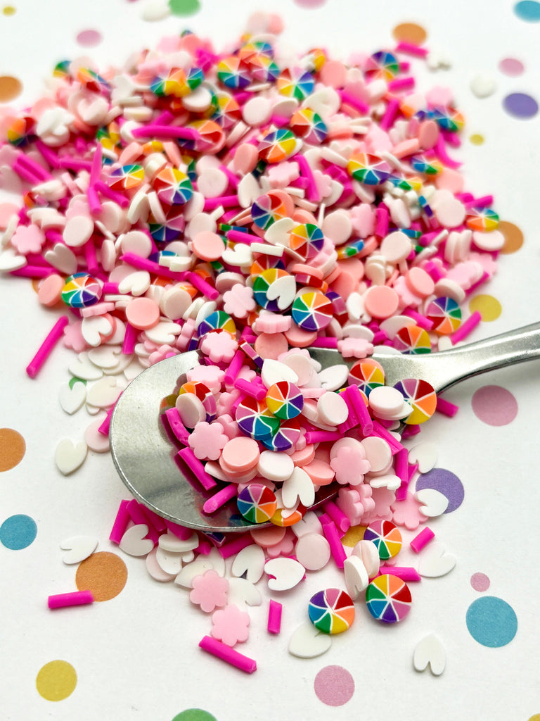 a spoon full of sprinkles on a table