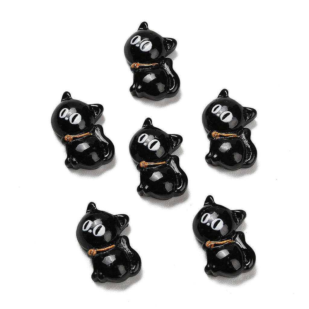 six black cat-shaped objects with white eyes, arranged in a circular pattern.
