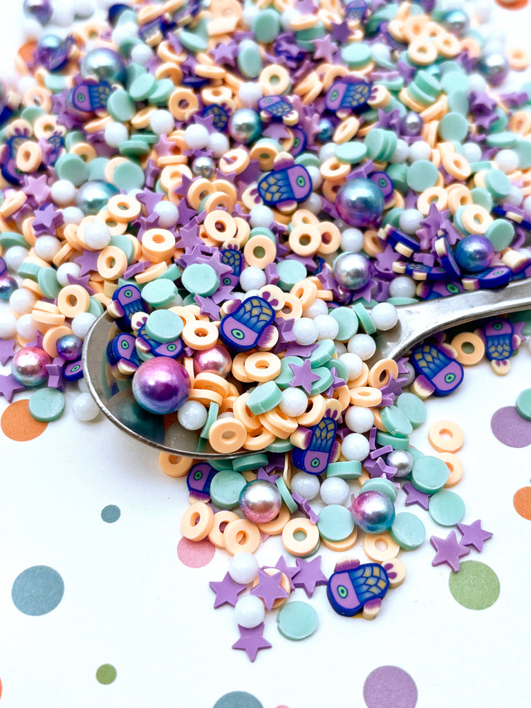 a spoon filled with lots of colorful beads