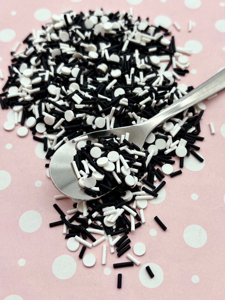 a spoon full of black and white sprinkles