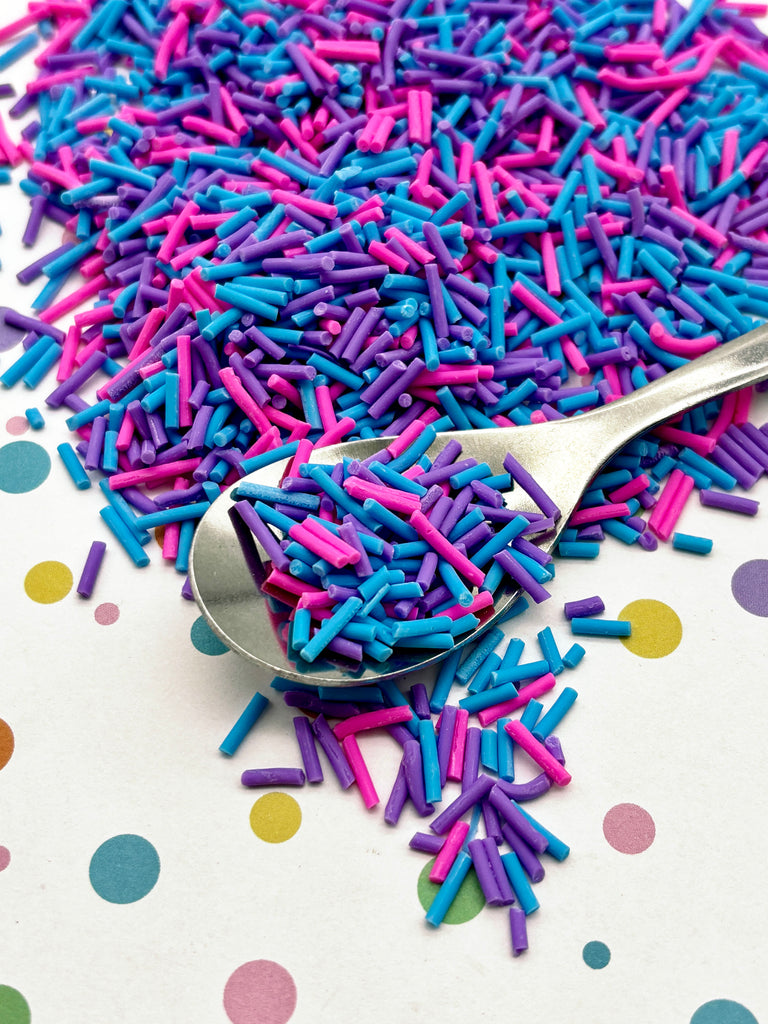 a spoon full of sprinkles on a table