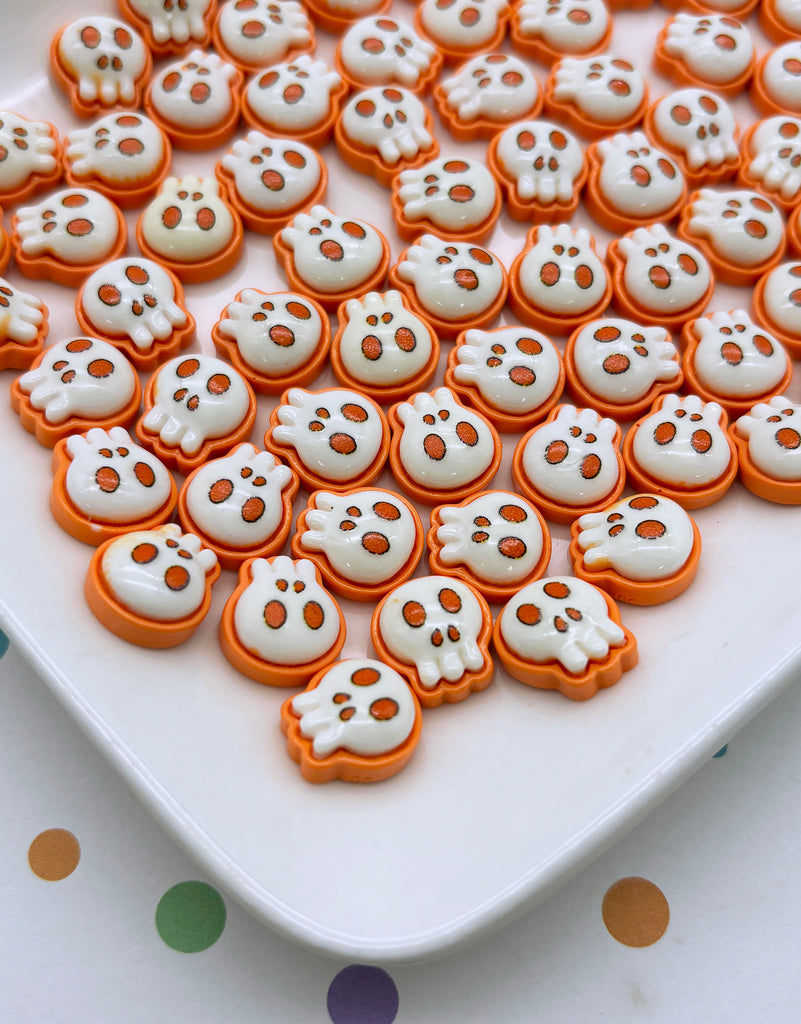 a white plate topped with lots of orange and white cookies