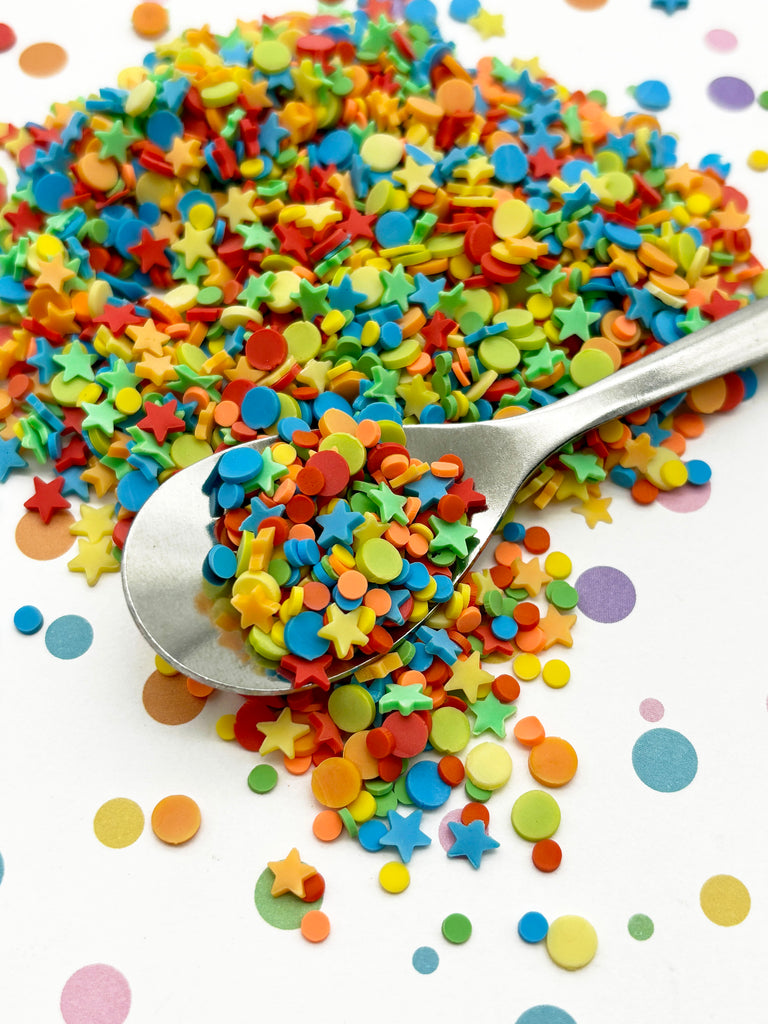 a spoon full of confetti on top of a table