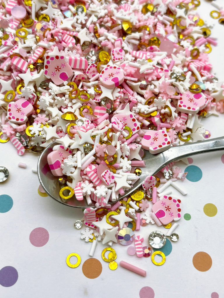 a spoon full of pink and gold confetti