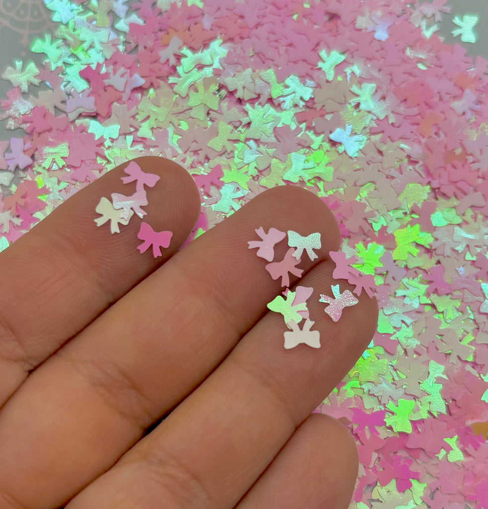 a person's hand with pink and green stars on it
