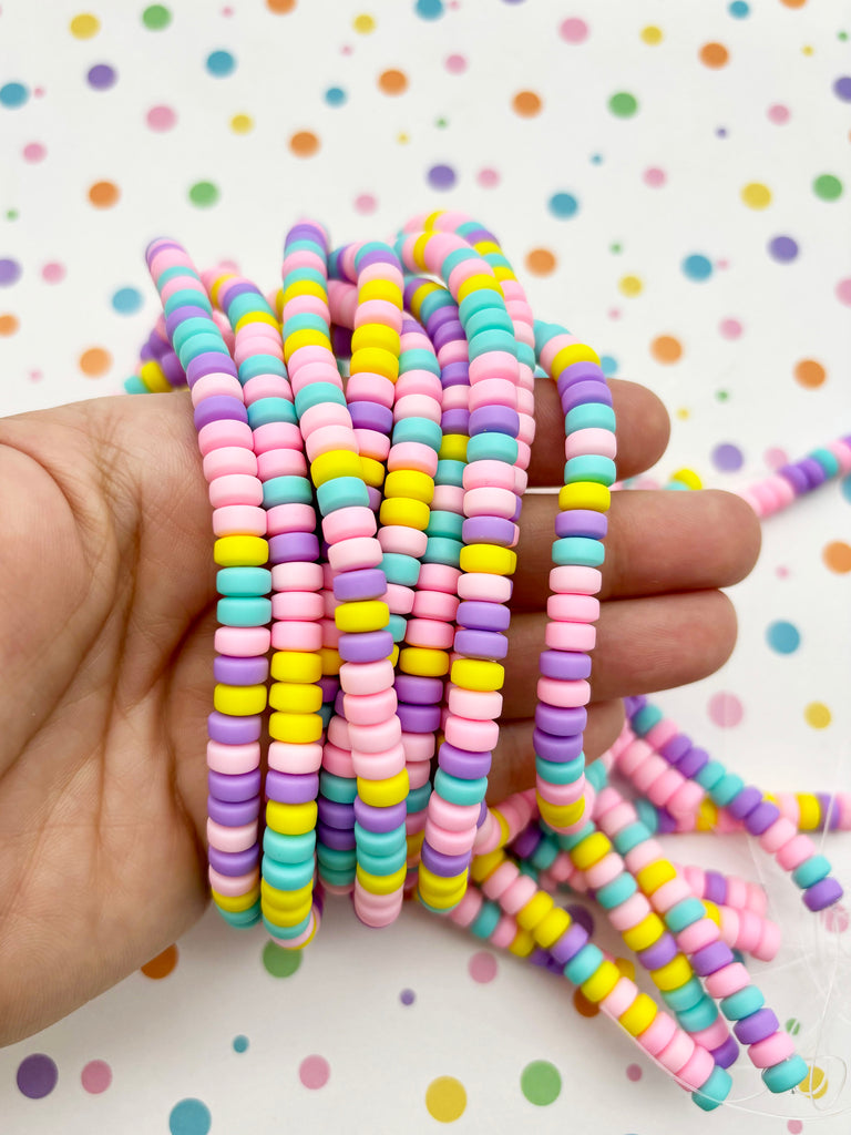 a hand holding a bunch of colorful beads