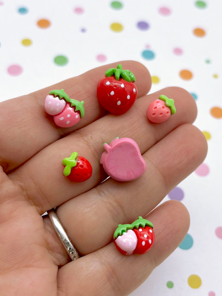 a hand holding a ring with some fruit on it