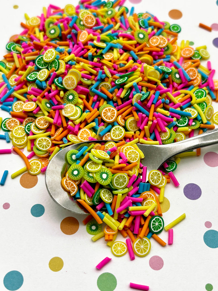 a spoon full of colorful sprinkles and lemon slices