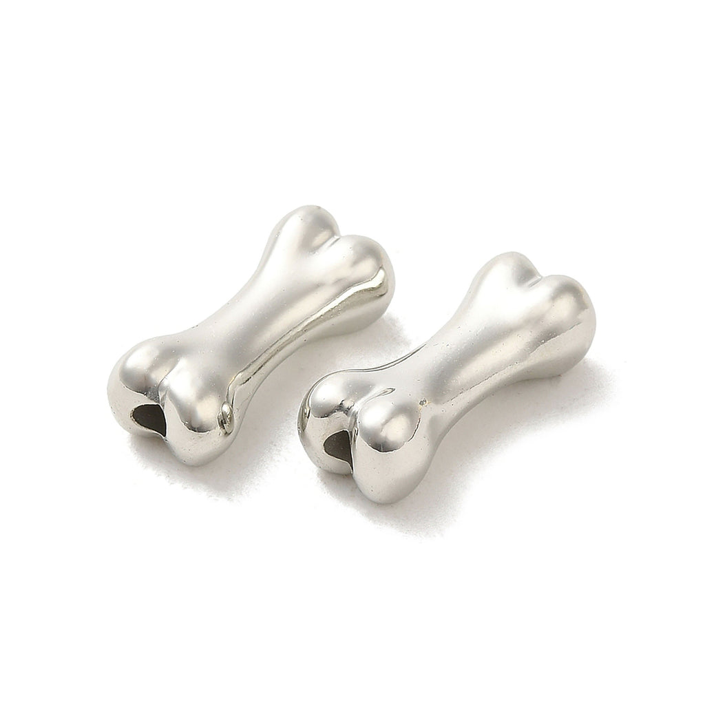 Two silver-colored metal bone-shaped objects are shown against a white background.