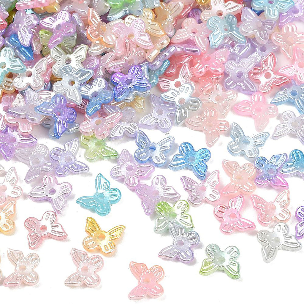 a collection of colorful, small, and transparent beads in various pastel shades, including pink, blue, purple, and yellow, scattered across a white background.