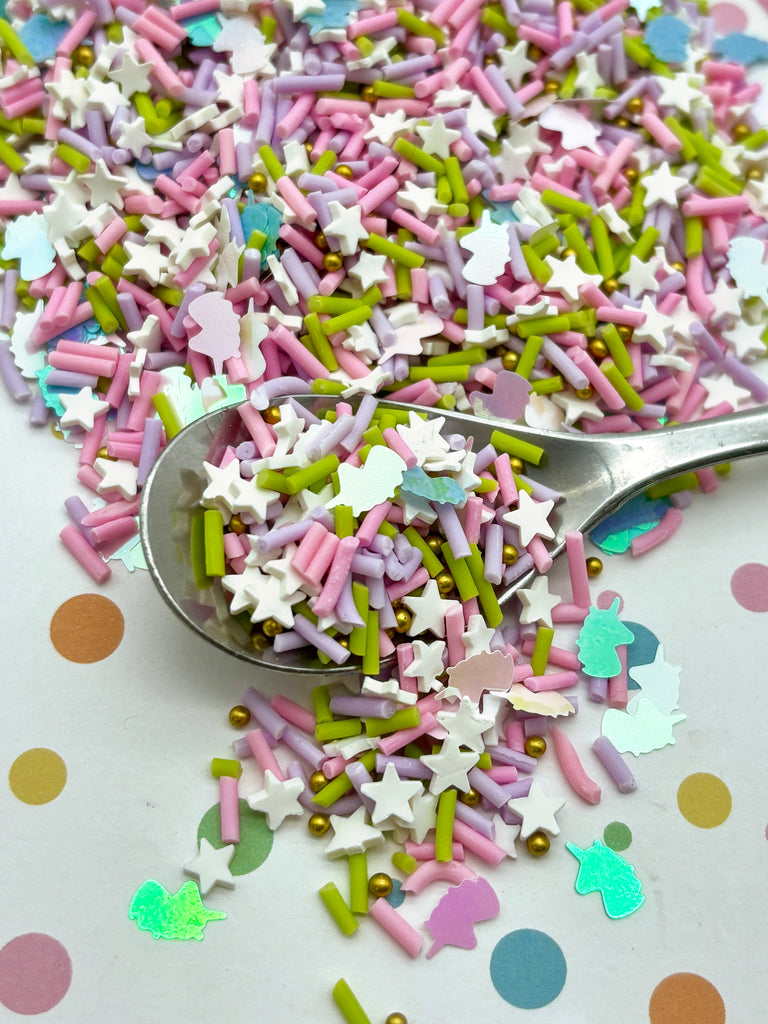 a spoon full of sprinkles on a table