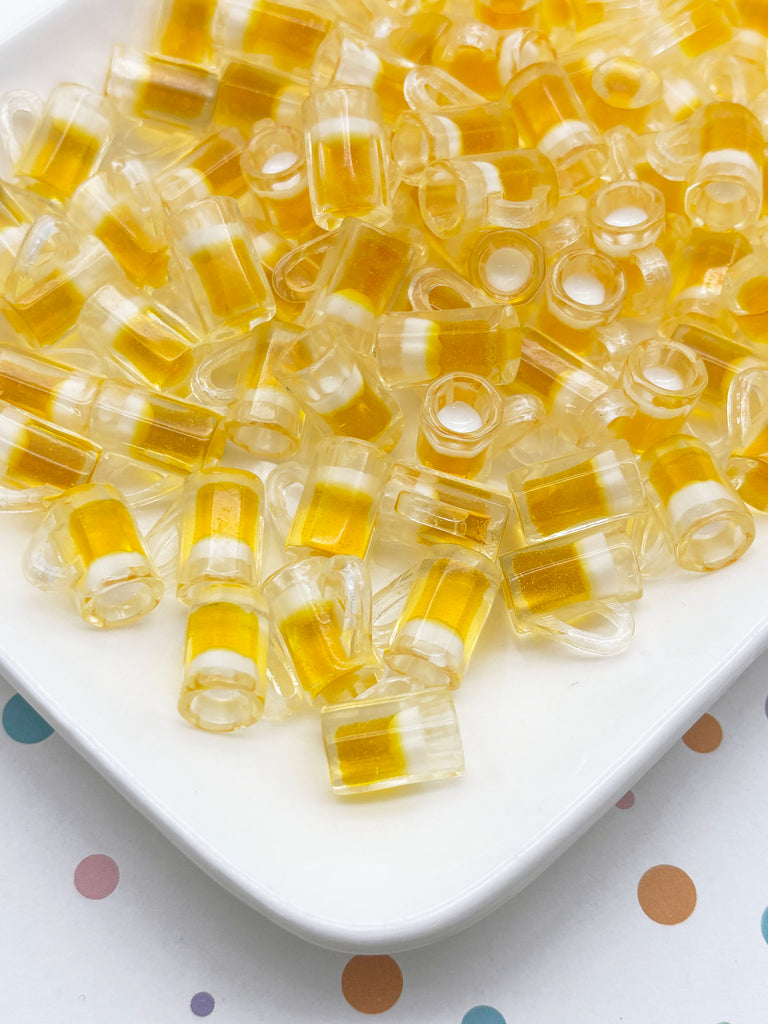 a white plate filled with numerous small, clear, yellow and white candy pieces, resembling a beer bottle cap.