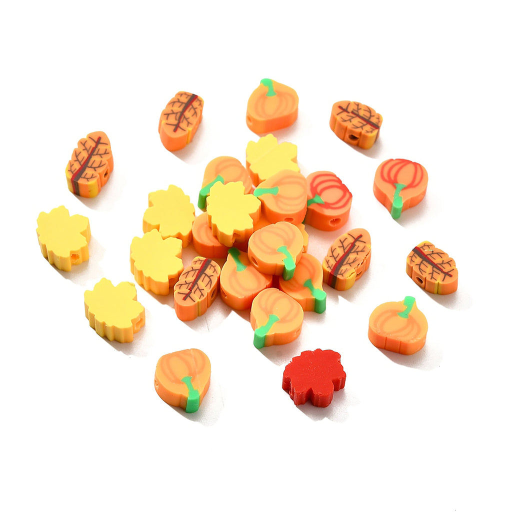 a collection of colorful, orange and yellow objects resembling leaves and pumpkins, scattered on a white background.
