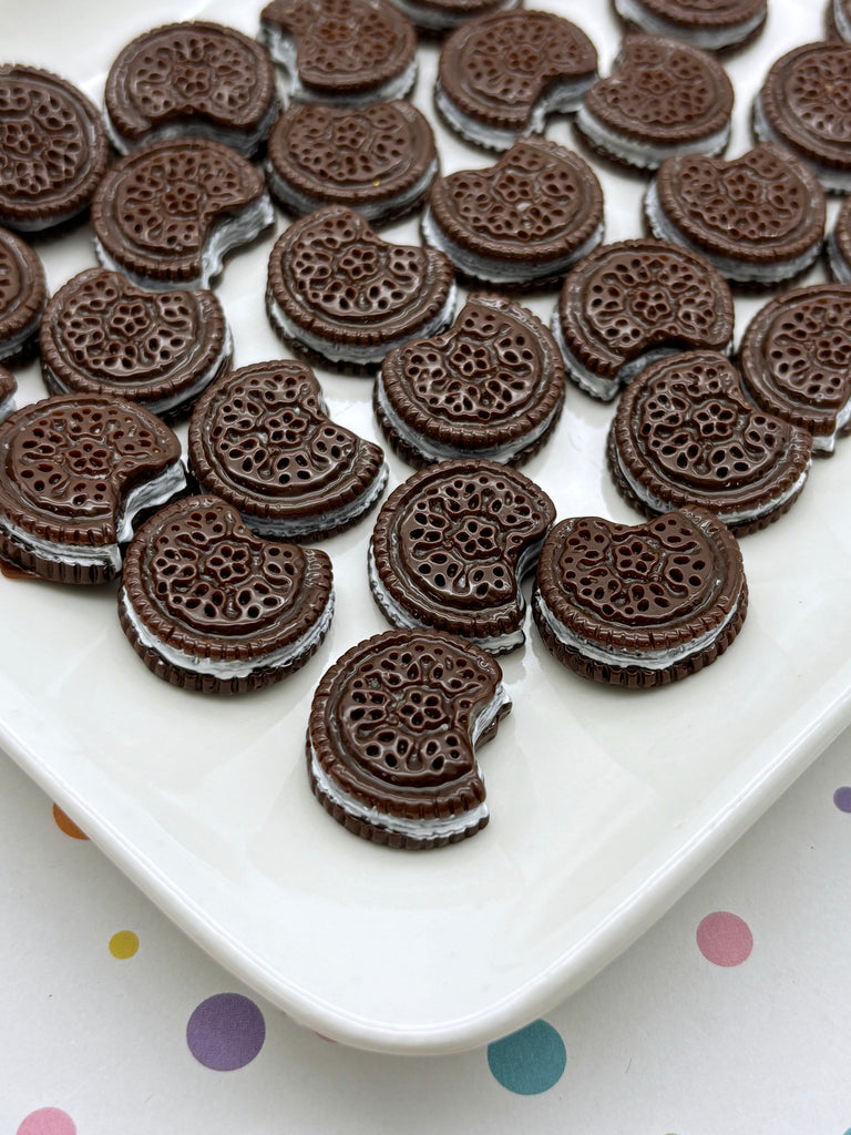 a white plate topped with chocolate cookies on top of a table