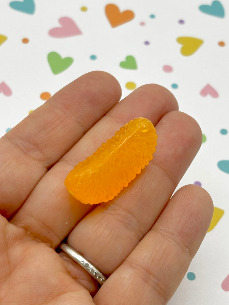 a person holding a piece of fruit in their hand