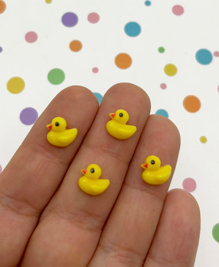 a hand with yellow rubber ducks on it