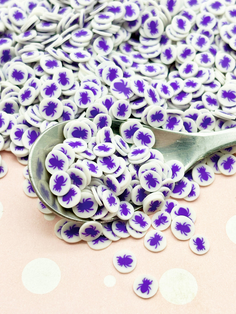 a spoon full of purple and white flowers