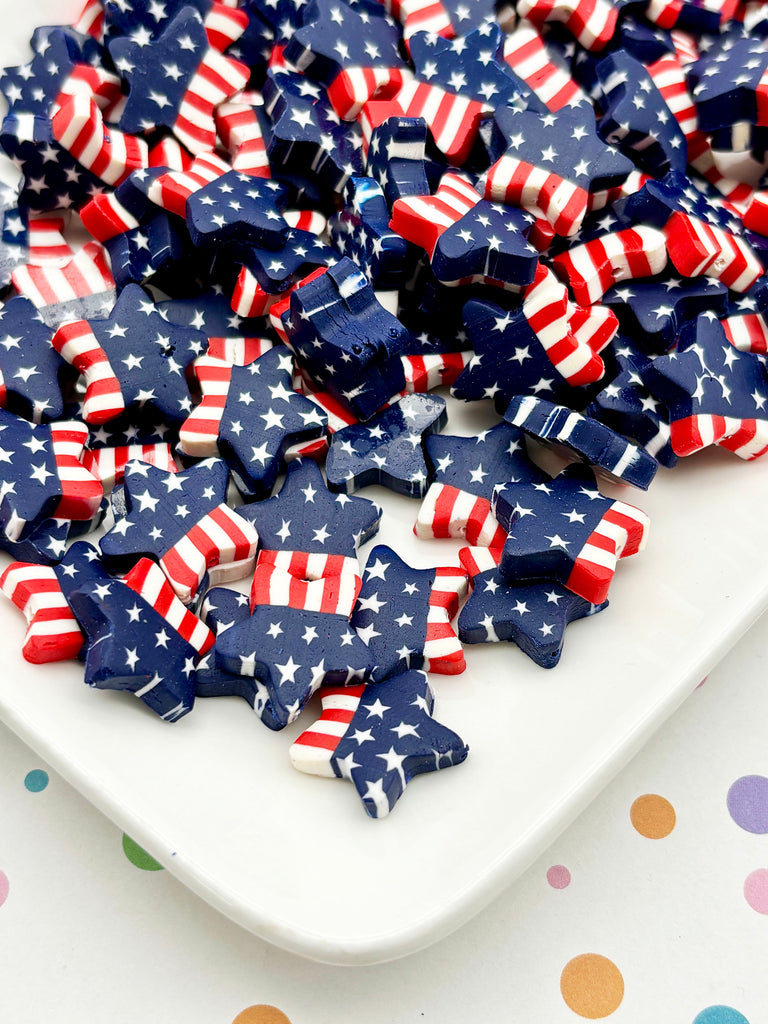 a white plate filled with numerous star-shaped objects, some of which are decorated with red, white, and blue colors, resembling the American flag.