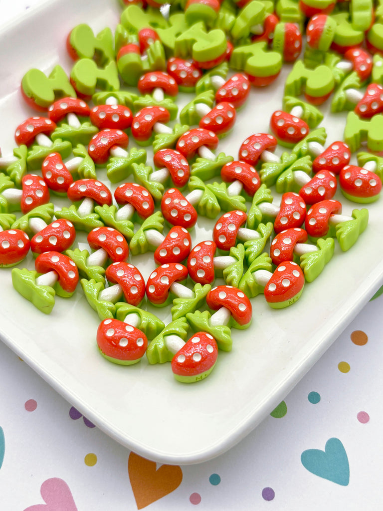 a white plate topped with green and red cookies