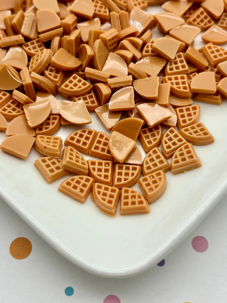 a white plate topped with waffles on top of a table