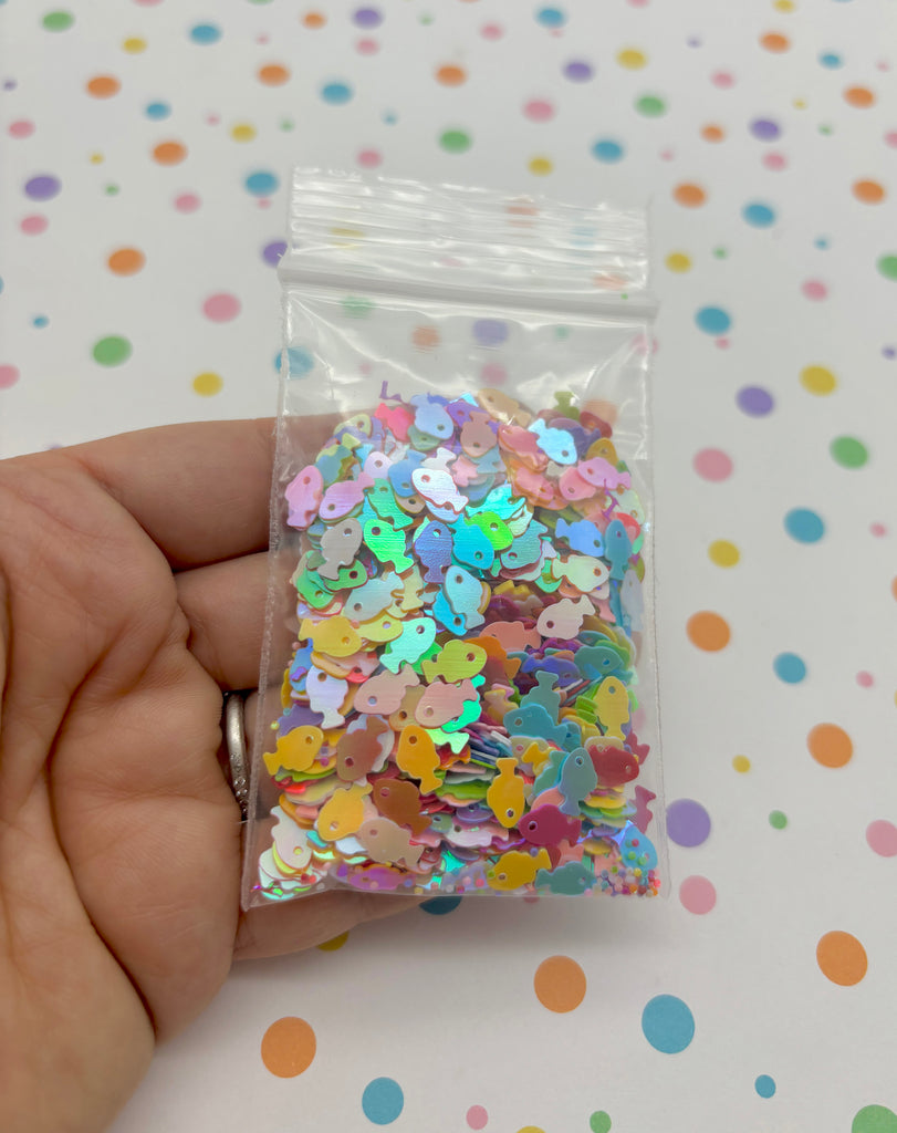 a hand holding a bag of colorful confetti