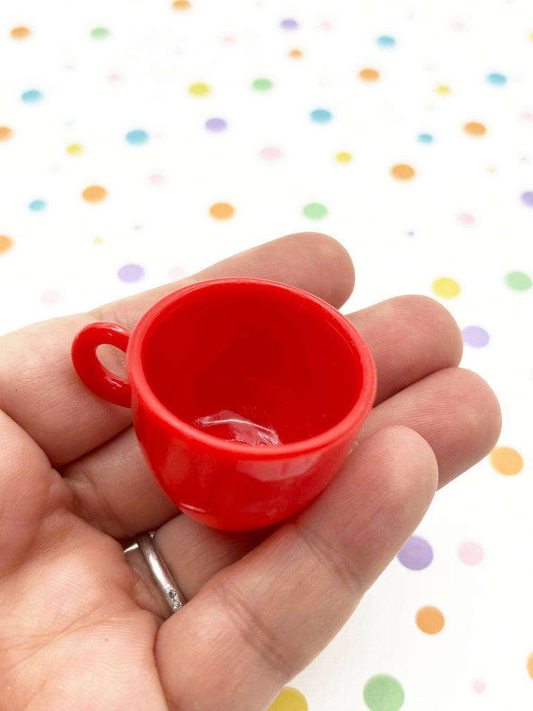 a person holding a red cup in their hand