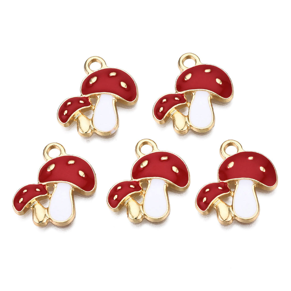 a set of four red and white mushroom charms