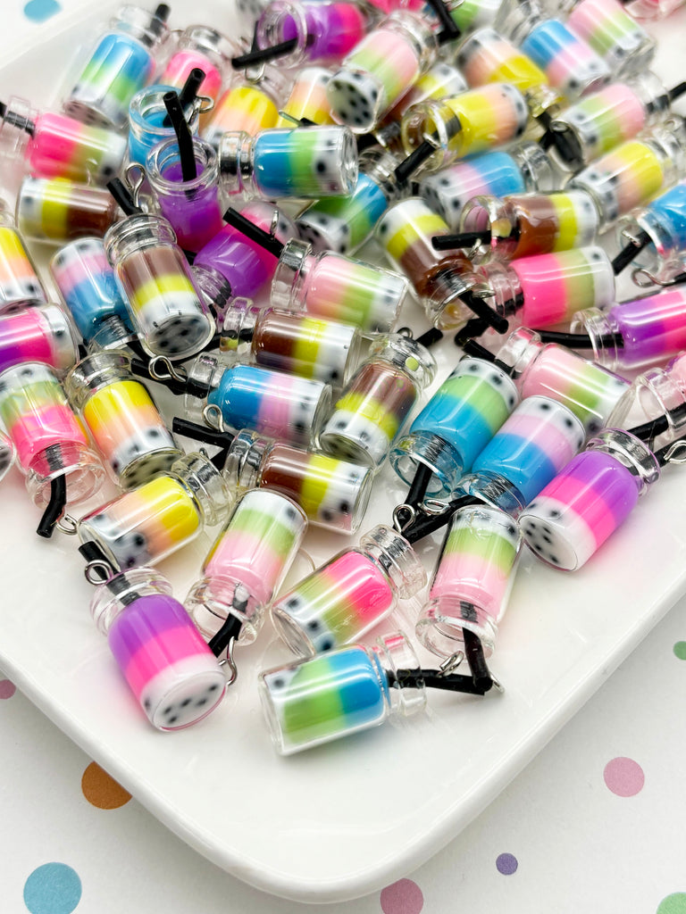 a white plate filled with colorful, multicolored objects resembling small bottles or containers, possibly containing a drink or other small items.