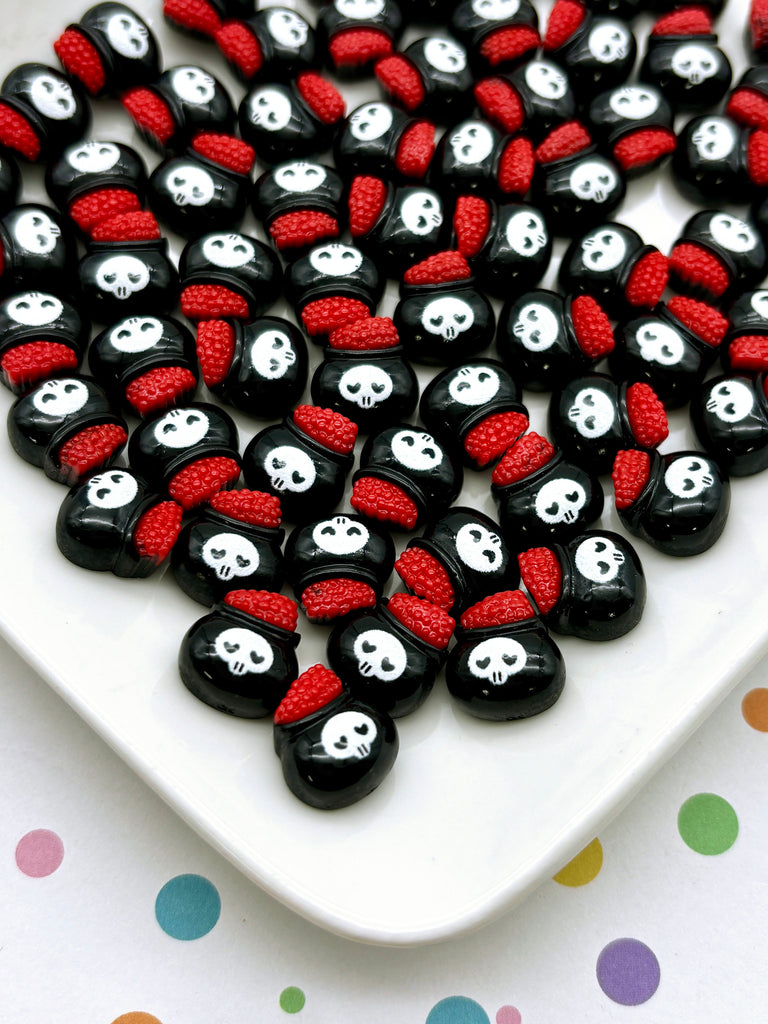 a white plate topped with lots of black and red skulls