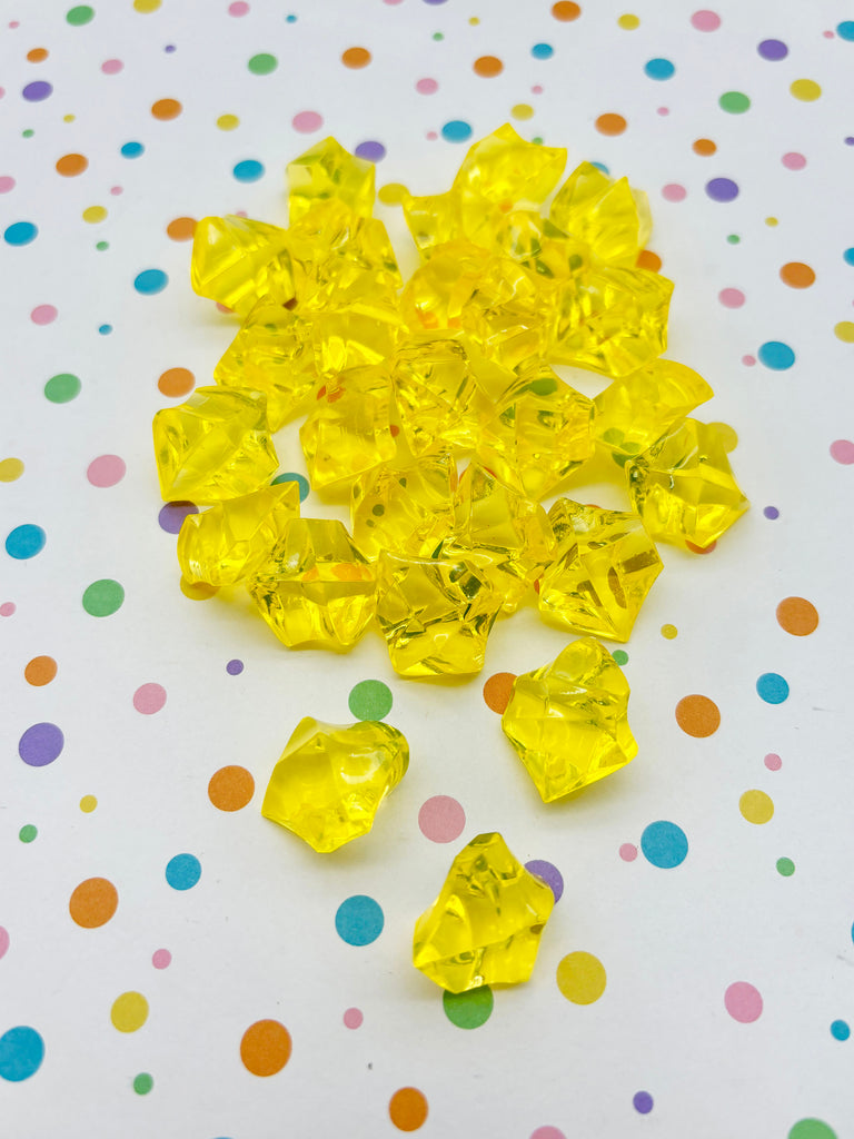 a bunch of yellow diamonds sitting on top of a table