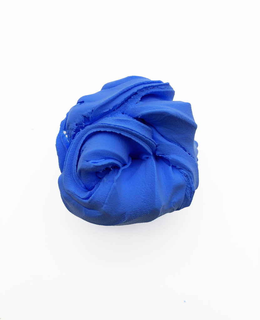 A single, blue, crumpled ball of play-doh is shown against a white background.
