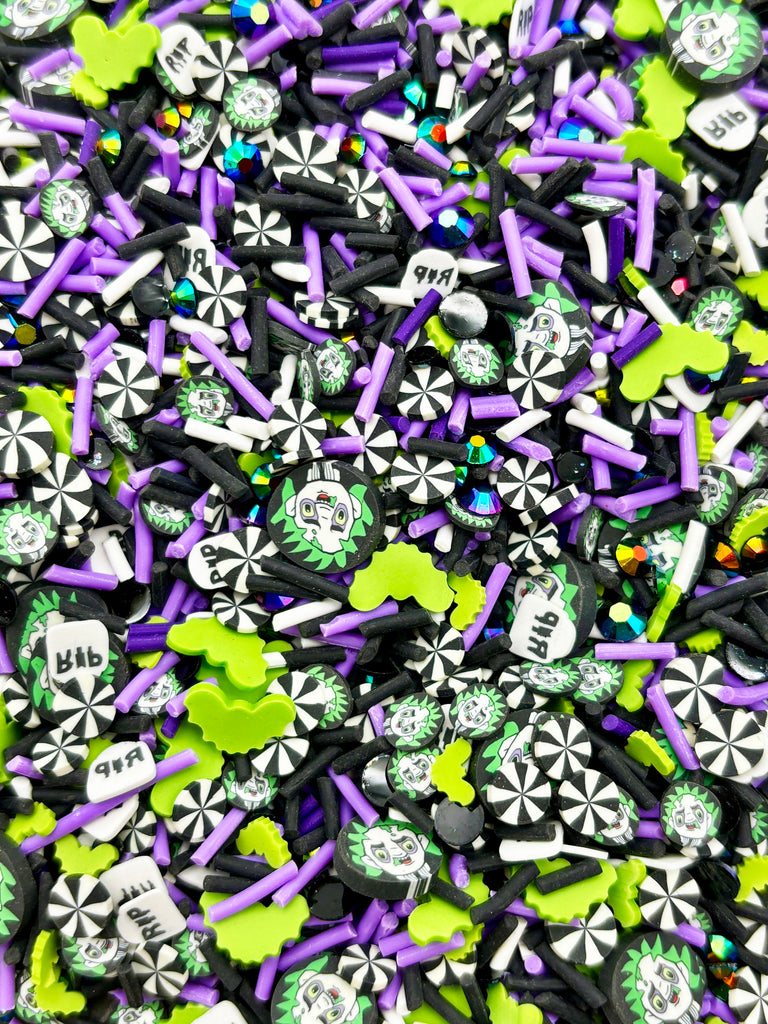 a pile of purple and green sprinkles next to each other