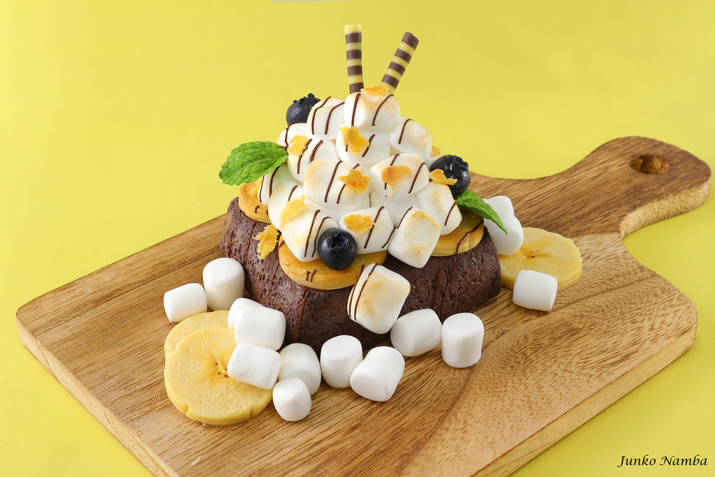 a dessert with marshmallows, chocolate, and other toppings