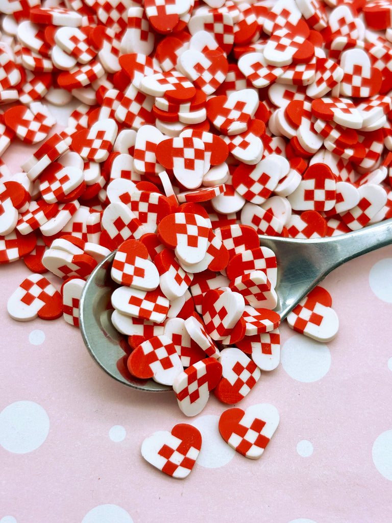 a spoon full of red and white hearts